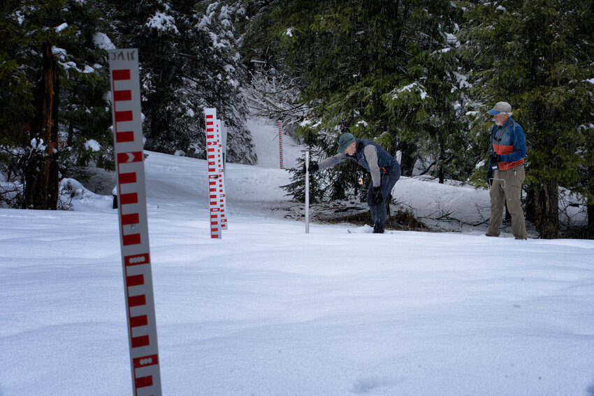 Joe Tedder and Bill Milner measure snow depth at the Jackson Mountain snowtography site. The coming snow season will be the second year of snowtography measurement.