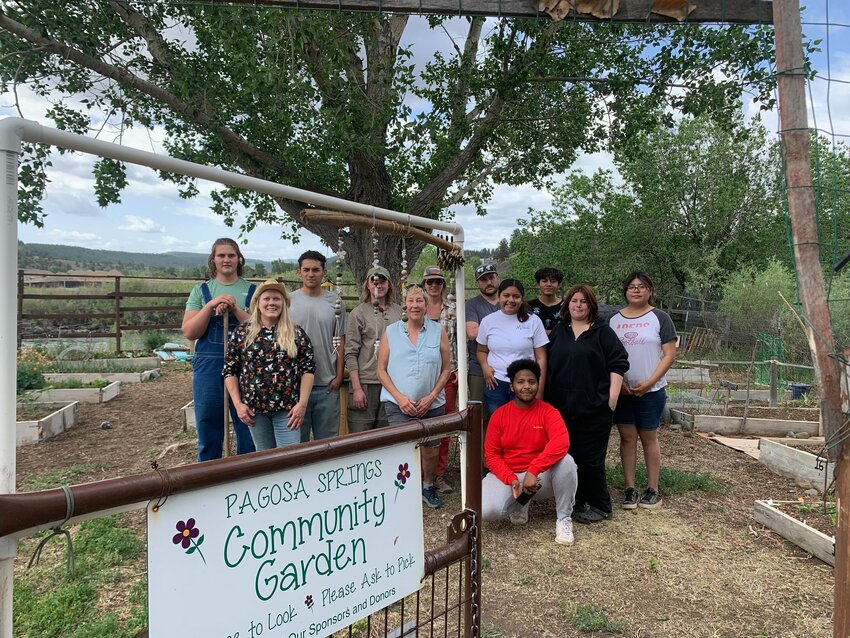 Healthy Archuleta team members, interns and guests from the Native American Bahá’í Institute pose at the Pagosa Springs Community Garden while helping with weeding and other maintenance.