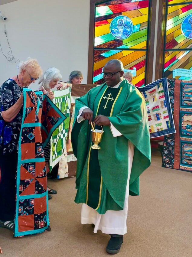 Prayer quilts created by the Pagosa Catholic Quilt Ministry are blessed during the Sept. 5 daily Mass by Father Francis Ejiro Ekere, a visiting Catholic priest from Nigeria. To date, 35 prayer quilts have been gifted.