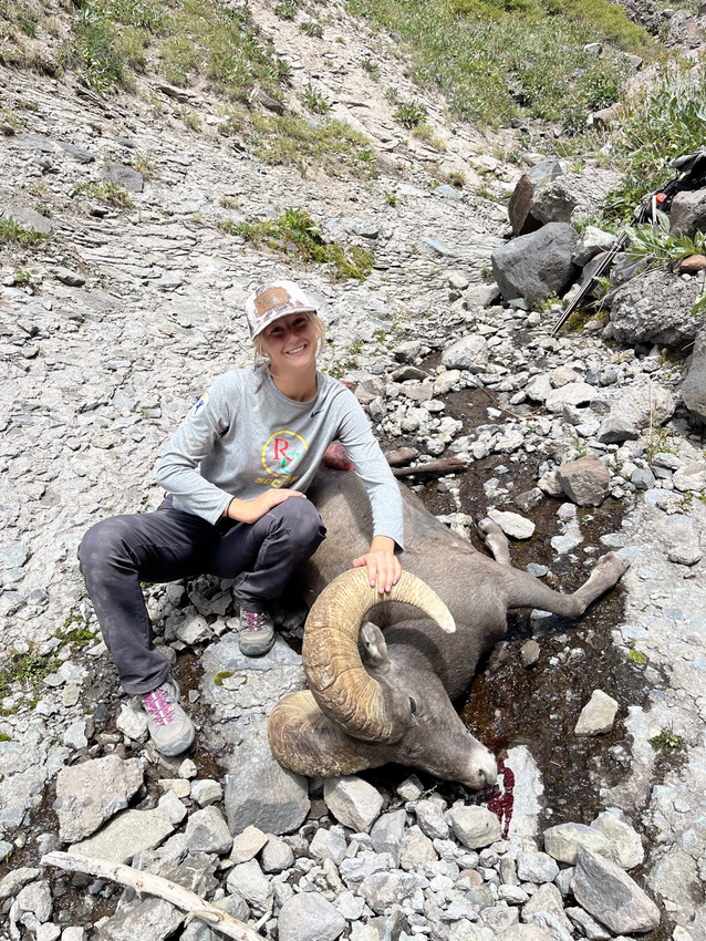 Noella Sarnow, 17, poses with the Rocky Mountain bighorn ram she harvested and is pictured during her hunt. Sarnow&rsquo;s hunt was a story of family history, friendships and sharing hunting with new generations.