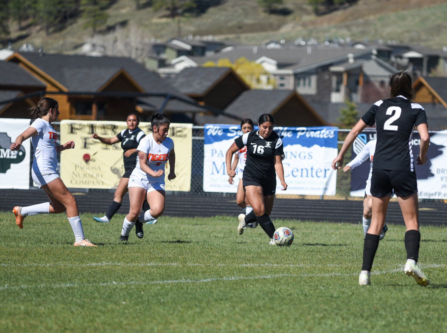 Lady Pirates Lauren Monterroso (left), Jeidy Moreno Echavarria (middle) and Elizabeth Currier (right), work to score during a match against Del Norte at home on April 30. Monterroso and Moreno Echavarria are both seniors, and the match against Del Norte was their last home game.