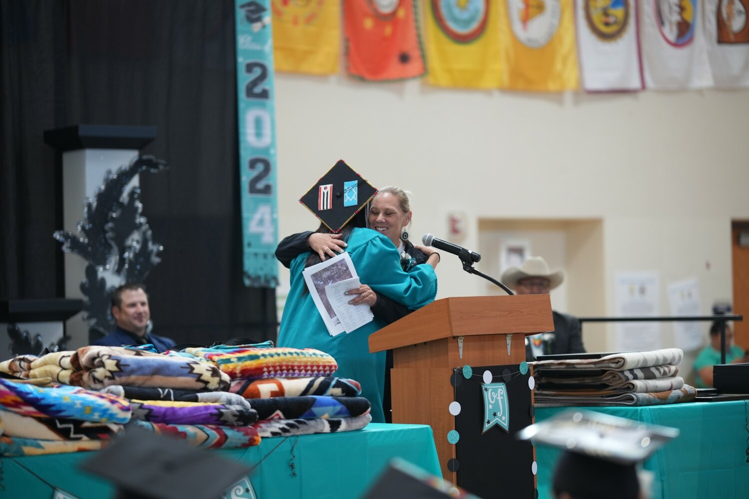 Katie Law hands out a diploma.