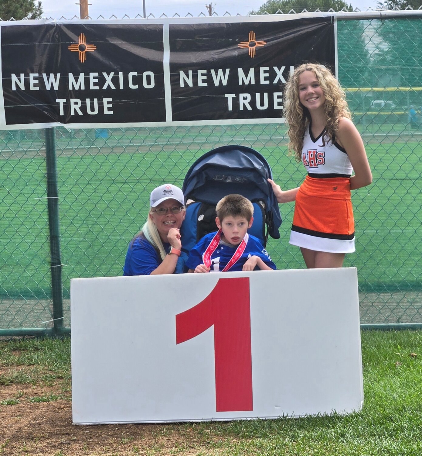 Jace Mills shows off his gold-medal finish in the softball skills event at the Special Olympics New Mexico Four Corners Invitational softball tournament in Farmington, N.M., on Saturday, Aug. 24.