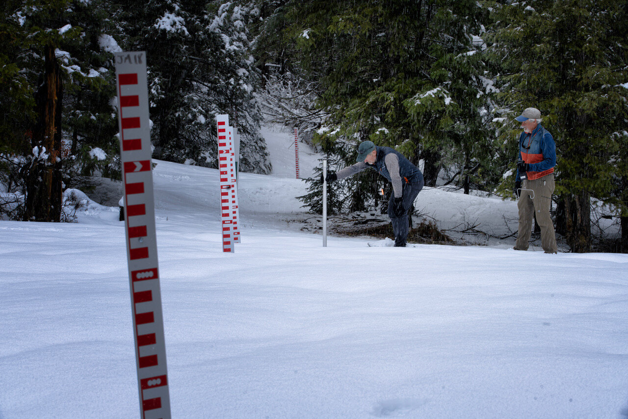 Joe Tedder and Bill Milner measure snow depth at the Jackson Mountain snowtography site. The coming snow season will be the second year of snowtography measurement.