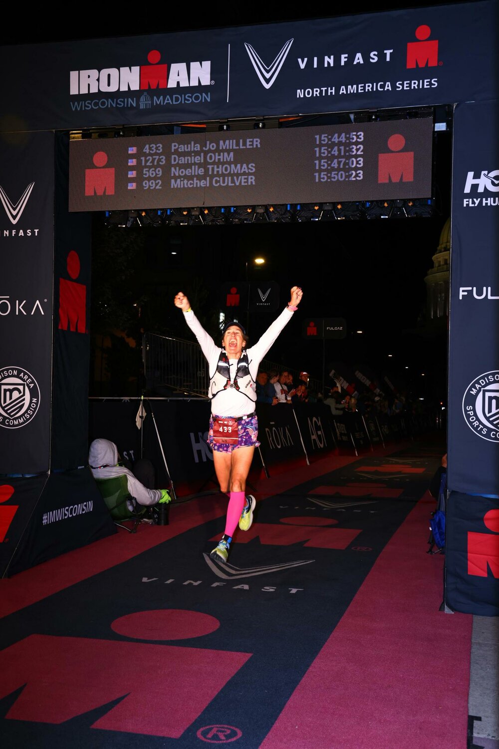 Paula Jo Miller celebrates her finish at the Ironman triathlon on Sept. 8 in Madison, Wisc. Miller described the support she received from family and friends along the way as “pure love.”