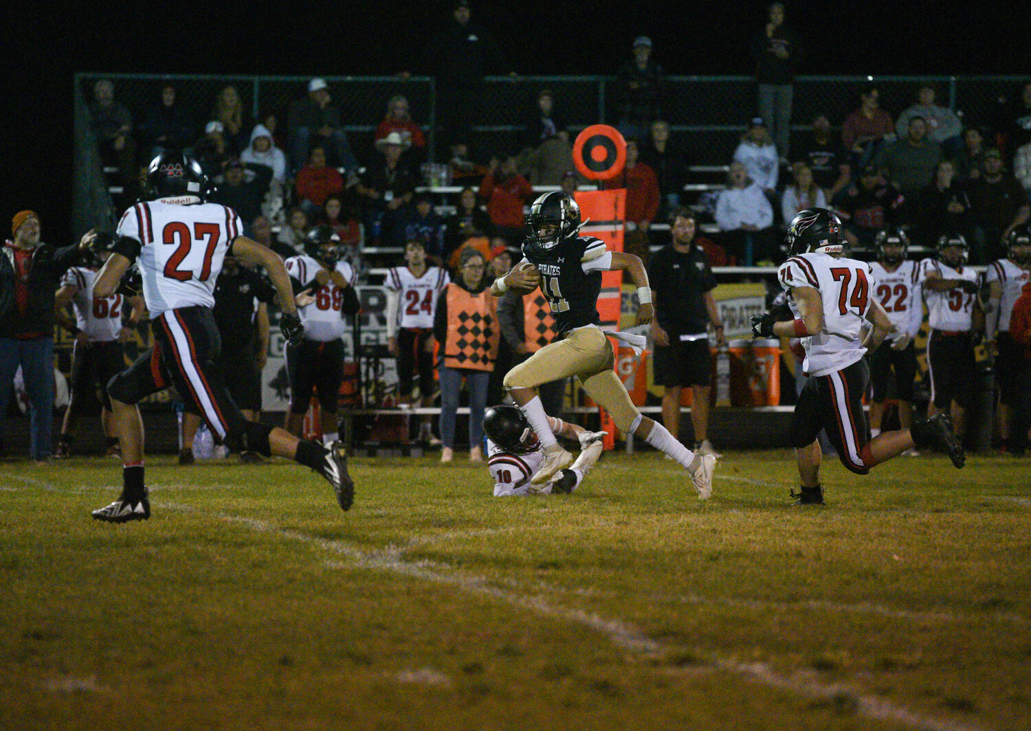 Pirate quarterback Creede Dozier breaks away from multiple Elizabeth tacklers while rushing the ball en route to scoring a touchdown. Dozier ran for 80 yards and one touchdown on the night.