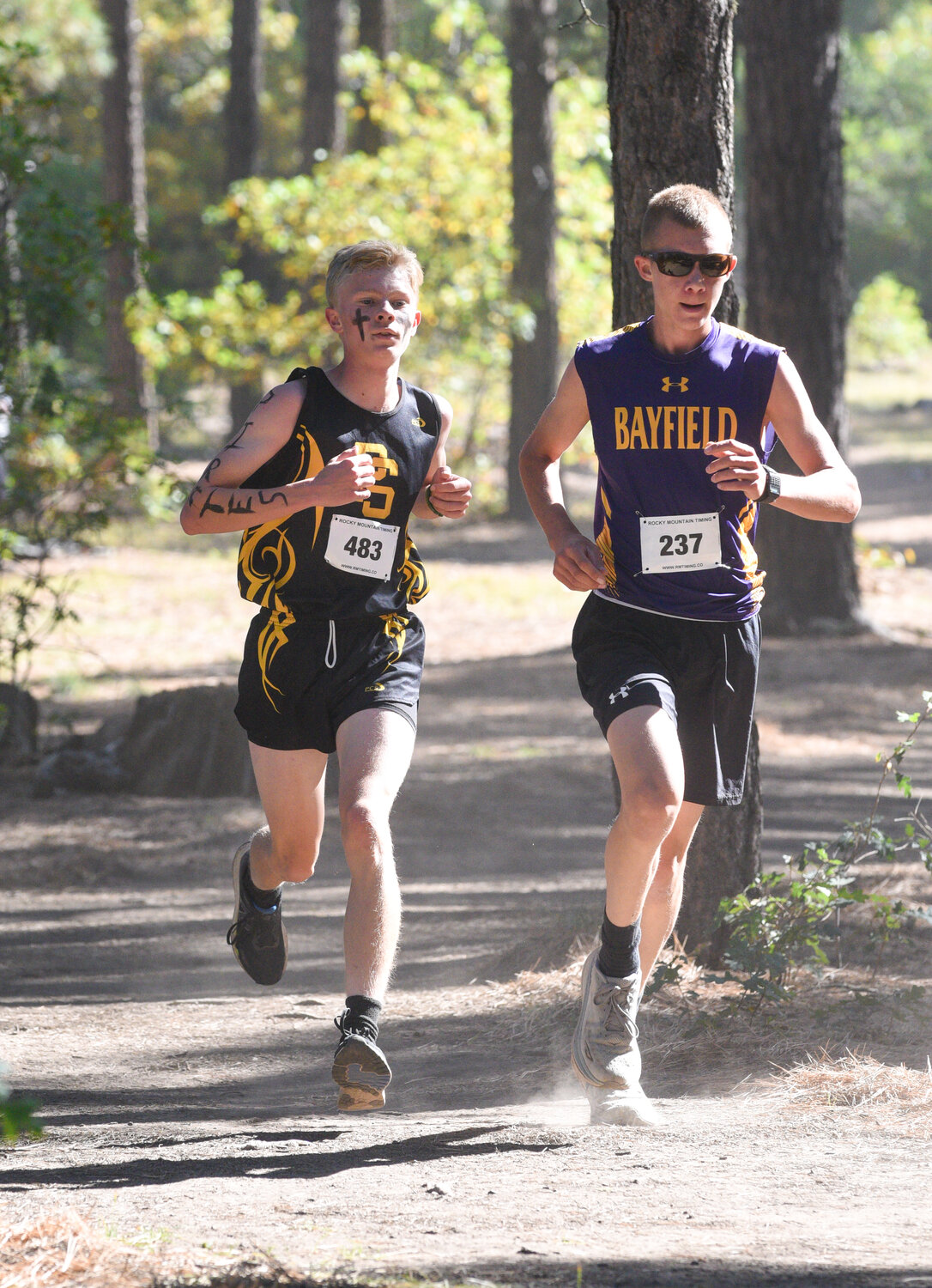 Pirate Connor Thomas runs near a Bayfield Wolverine during Saturday’s McGinn Memorial Cross Country Challenge on Reservoir Hill. Thomas was named to the all-conference first team after finishing fifth among league runners.