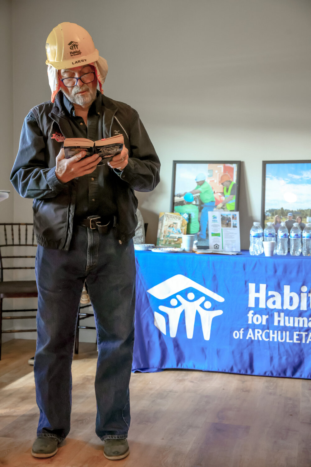 Core volunteer Larry Parks reads an excerpt at the 2024 Habitat for Humanity of Archuleta County house dedications.