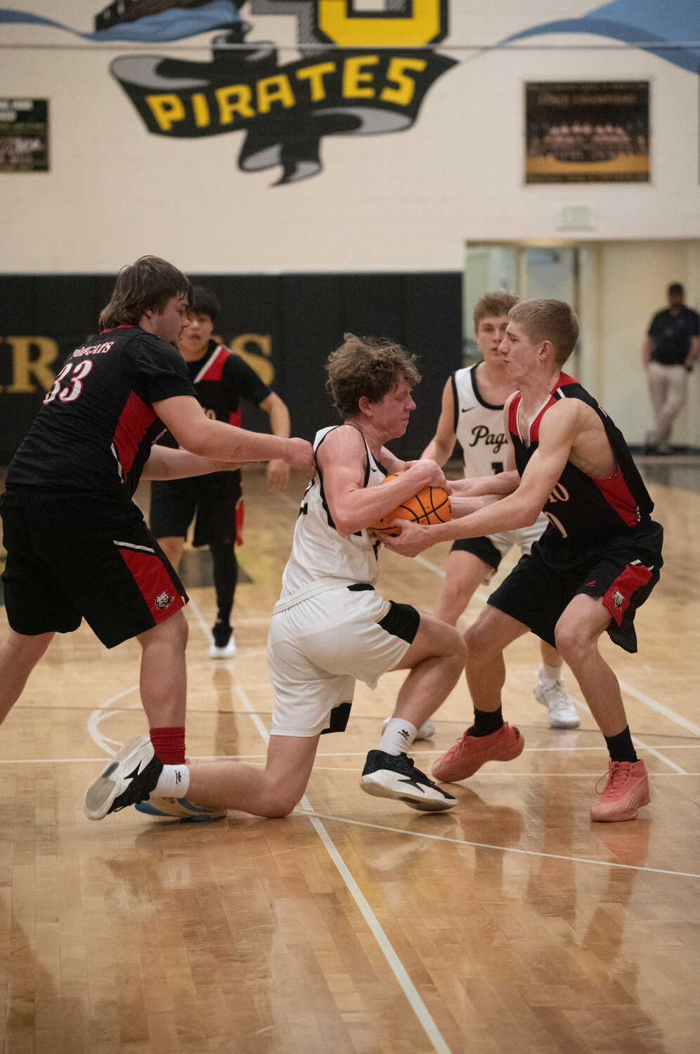 SUN photo/Randi Pierce
Jaxten Scheil finds himself surrounded by Ignacio Bobcats while fighting for possession of the ball Saturday in Pagosa Springs. The Pirates battled to defeat the visitors 51-45.