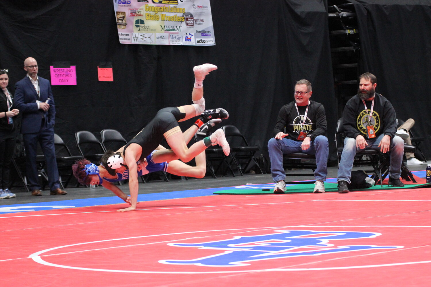 Anthony Manzanares flies through the air with an opponent from the state wrestling tournament in Denver last week. Manzanares earned sixth place in the 106-pound weight class, ending his high school career with 63 varsity wins.