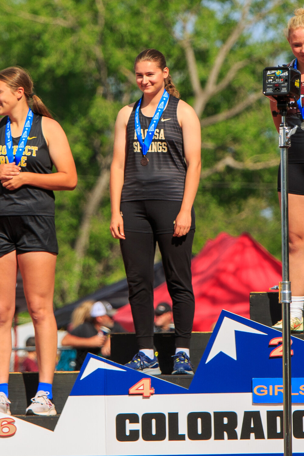 Abigail Nehring stands on the podium after finishing fourth in the girls’ shot put.
