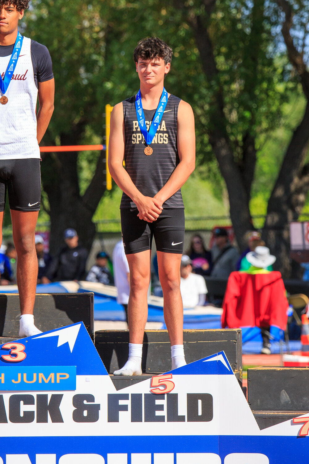 Creede Dozier stands on the podium after finishing fifth in the boys’ high jump.