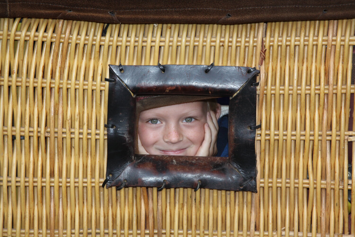 Miles McCrudden peeks out of a hot air balloon basket. Wings Early Childhood Center will host an end-of-summer event on Aug. 23 that will feature tethered hot air balloon rides.