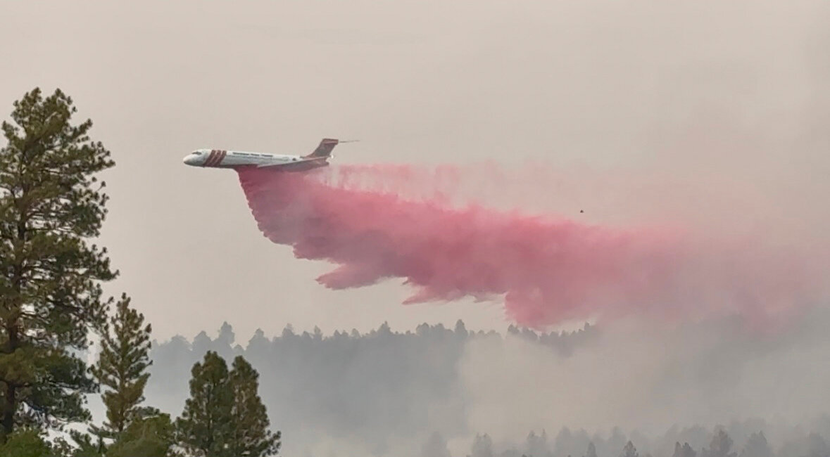 Left: The Oak Fire burns just west of Pagosa Springs in the Aspen Springs area. Top: An air tanker drops retardant on the Oak Fire. The fire, which was started by an illegal burn on Sunday, Aug. 10, burned 75 acres and prompted evacuations.