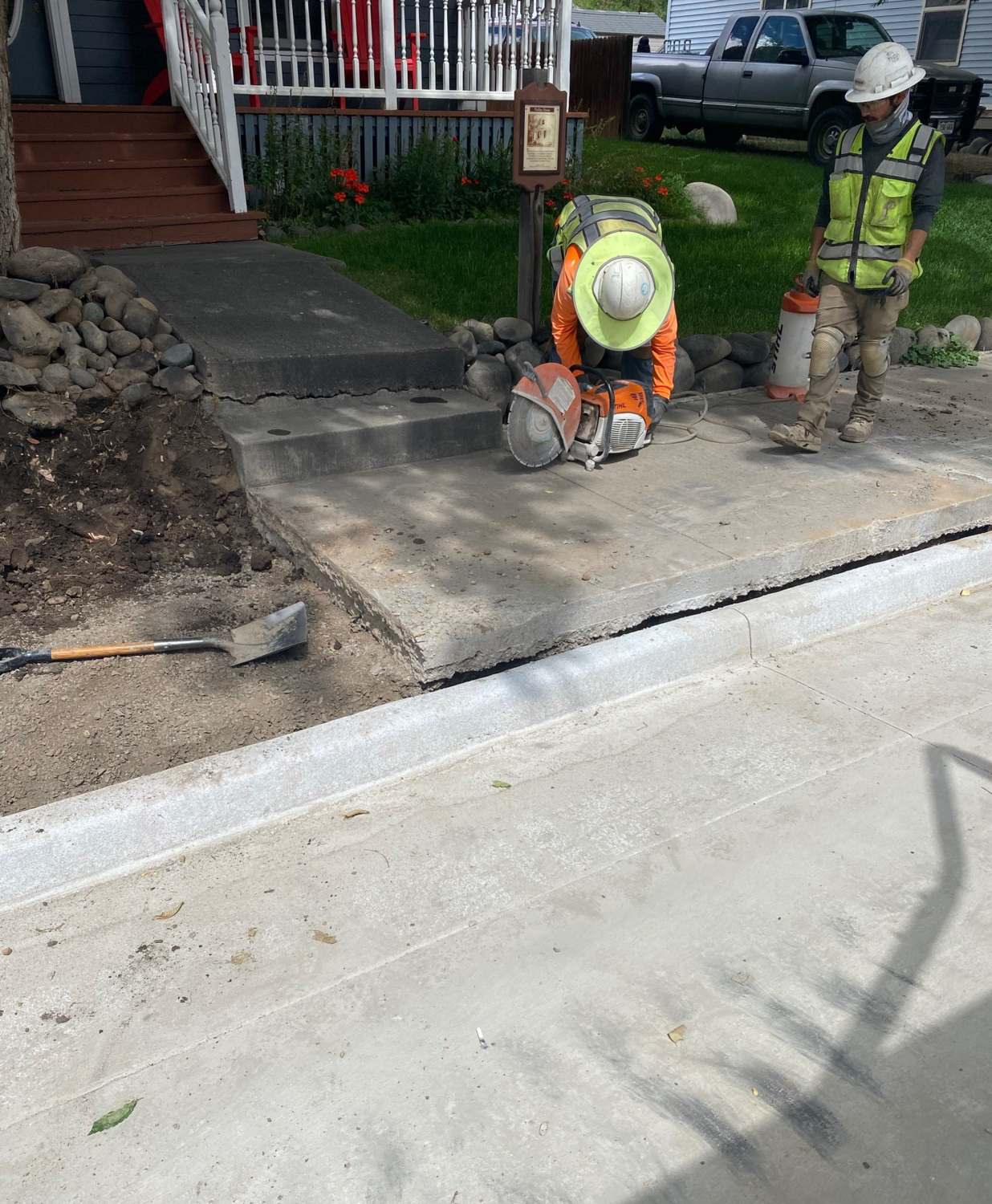 A construction team works to match the new sidewalks with existing property infrastructure.