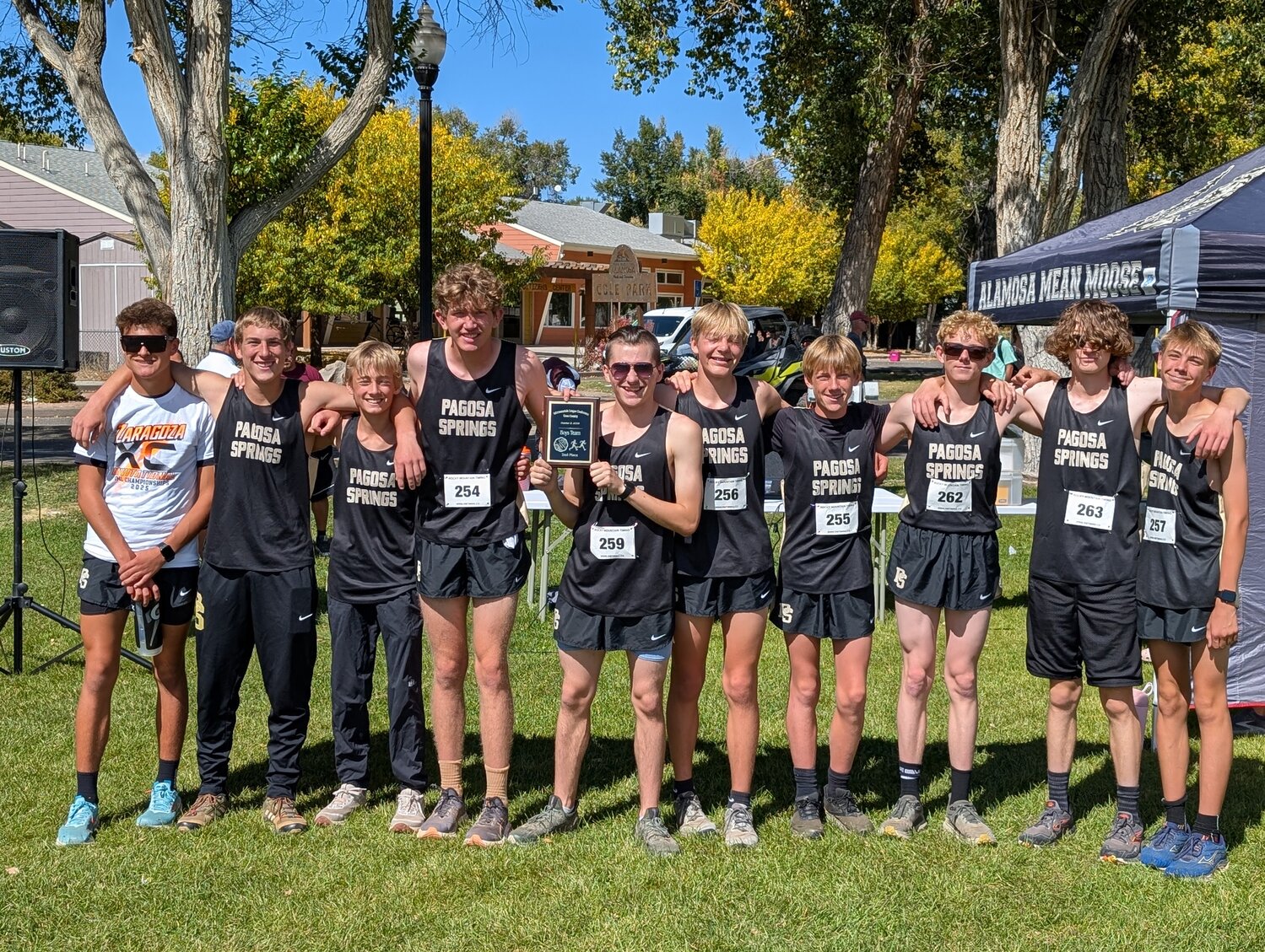 The Pirate cross-country team poses with a plaque after finishing second in the Intermountain League meet in Alamosa on Friday, Oct. 3. Rylan Ash, left, also earned individual all-conference honors.