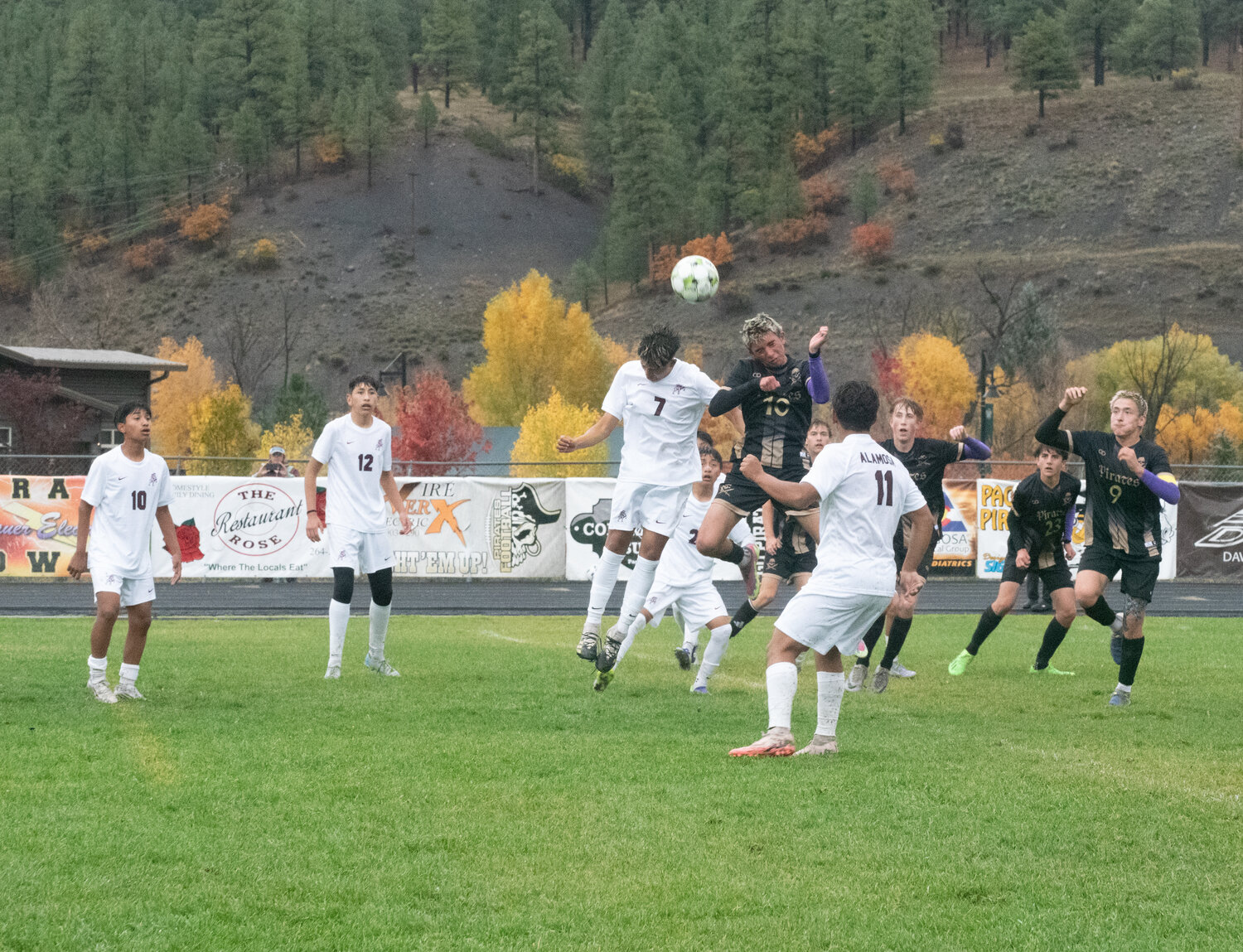 Jacob Castaneda leaps to win a header against an Alamosa defender during the Pirates&rsquo; 5-0 win on Friday, Oct. 10.