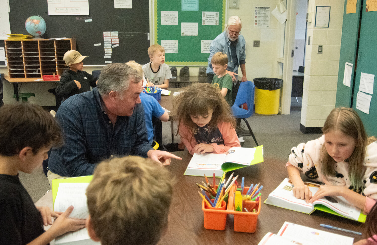 Rotarians and Pagosa Springs Elementary School third-graders explore the students&rsquo; new dictionaries. In annual tradition, every third-grader received their own dictionary, with Rotarians then exploring the reference books with them.