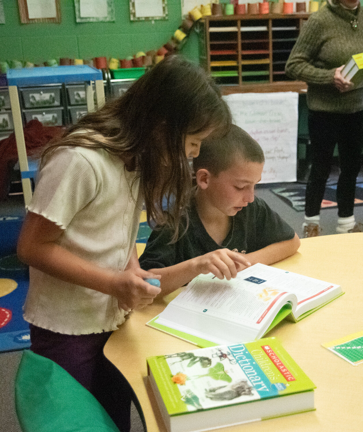 Local Rotarians hand out more than 100 dictionaries to Pagosa Springs Elementary School third-graders and dive into the new books together. Rotarians encouraged the children to look up various words and to explore other sections of the book, such as state and country flags, maps and presidents.