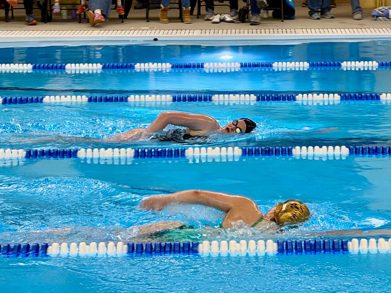 Asia Gorman, back, swims the 400-meter freestyle at the Lady Pirates&rsquo; season opener in Salida Tuesday, Dec. 2.