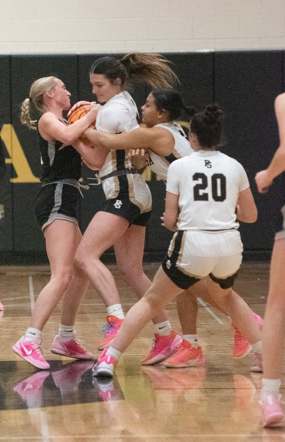Lady Pirates Lexi Campbell, Charity Domingo and Amber Snarr fight to gain possession during the team&rsquo;s game against the Salida Spartans on Saturday, Dec. 13. Despite outscoring the Spartans 24-12 in the second half, the Lady Pirates lost 32-31.
