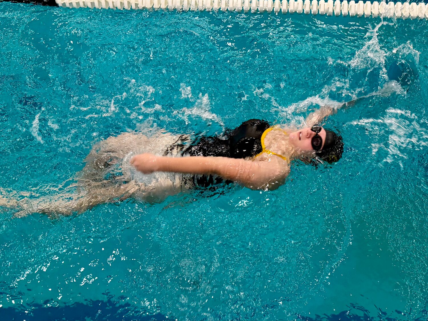 Lady Pirate Brooklyn Trujillo swims the backstroke at the team&rsquo;s meet against Sargent on Dec. 18 at Adams State University. Sargent triumphed 82-81, with Lady Pirate coach Heather Miller highlighting the Pirates came closer to defeating their opponent than they have in years.