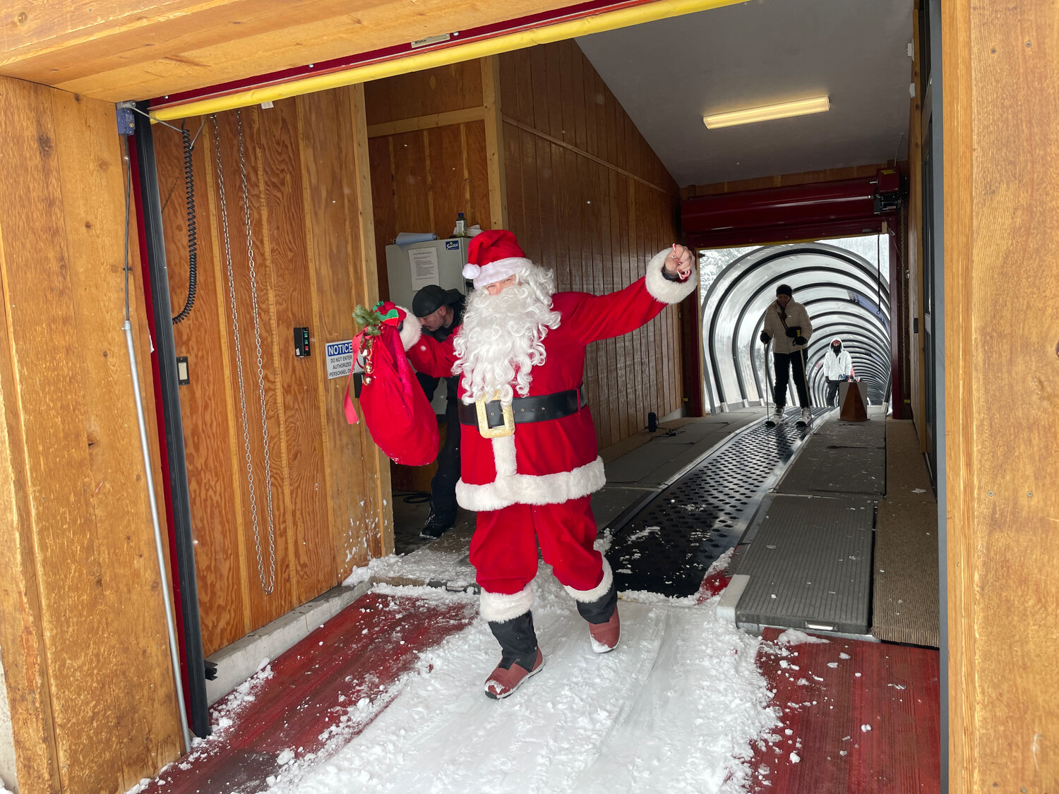 Santa emerges at Wolf Creek Ski Area on Christmas. Left: Oakley, dressed for the holiday, poses with his dogloo. Oakley and his dogloo have become a fixture at the bottom of the Elma lift over the years. Scott Bradford reports that, even with the current snow levels, Oakley has a two-story dogdominium.