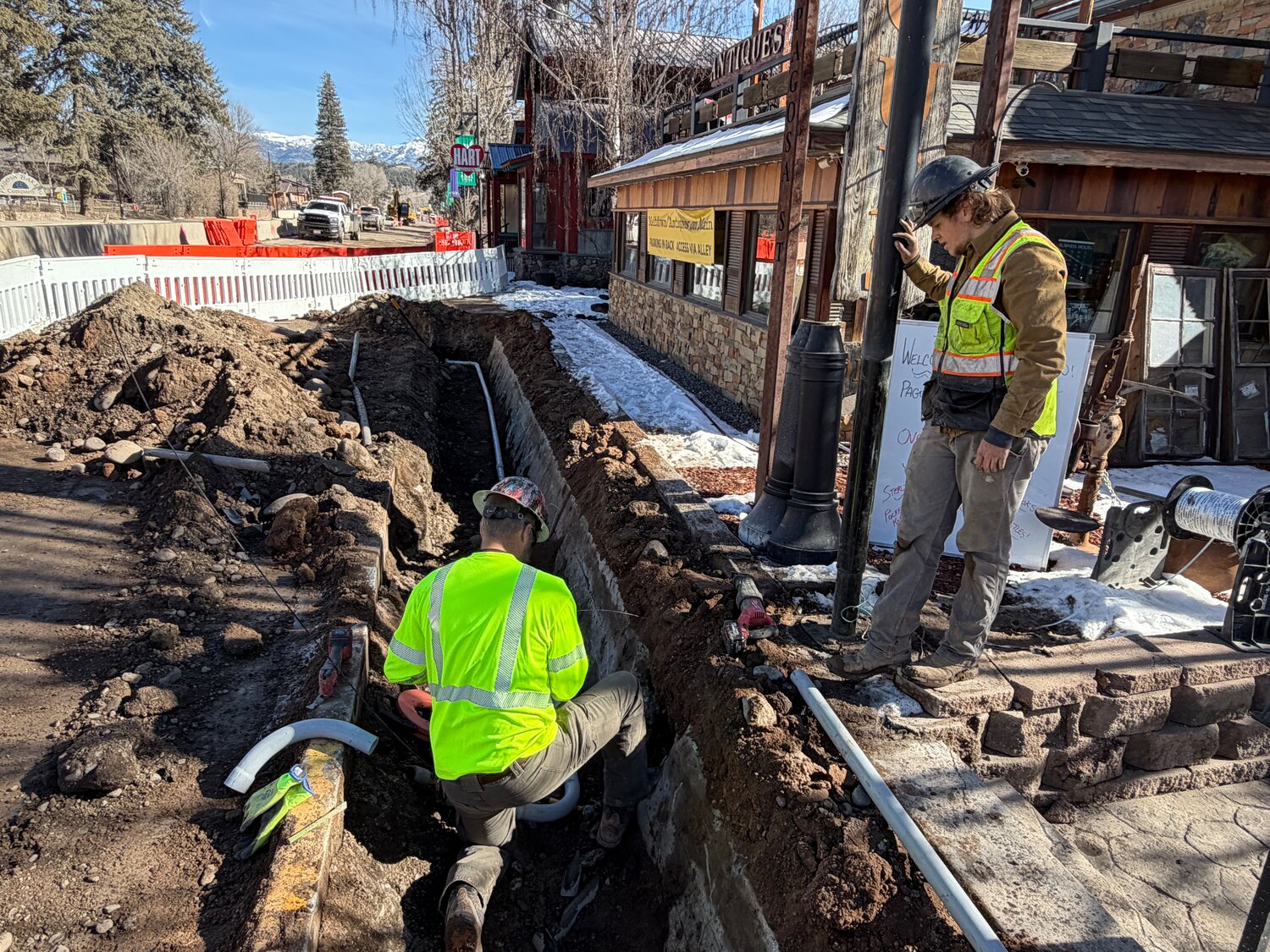 Construction crew members work on stormwater utilities along U.S. 160. The Colorado Department of Transportation notes stormwater utility work requires coordination with multiple utility agencies, such as electric, to mitigate potential conflicts.