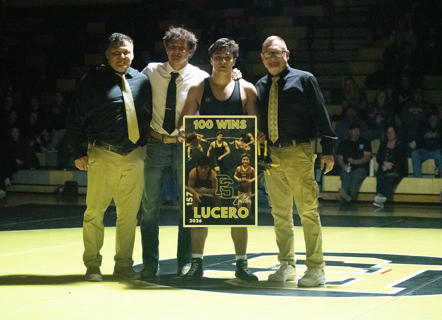 Colton Lucero, second from right, poses with David Lucero, Cameron Lucero and Dan Janowsky after logging his 100th high school win on Thursday, Jan. 22.