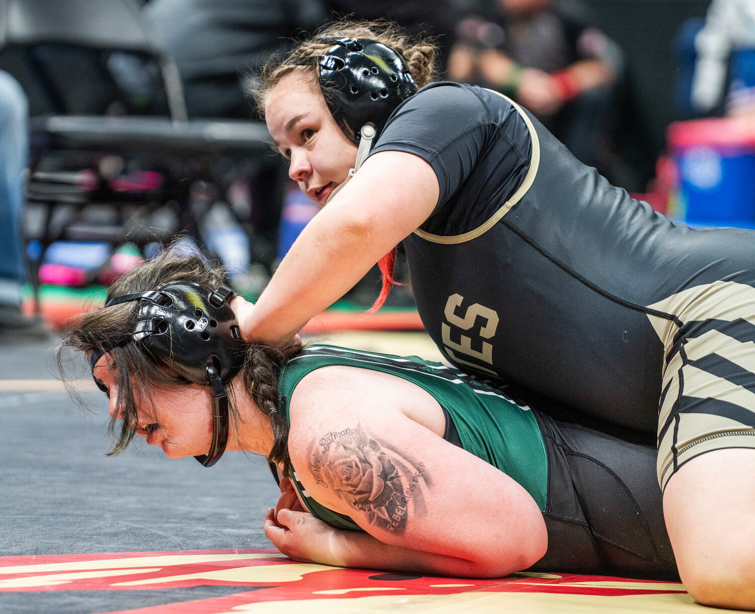 Lady Pirate Laykyn Baxstrom looks up while controlling an opponent at last week&rsquo;s state championship. Baxstrom earned second in her weight class and ended the season with a 28-2 record.
