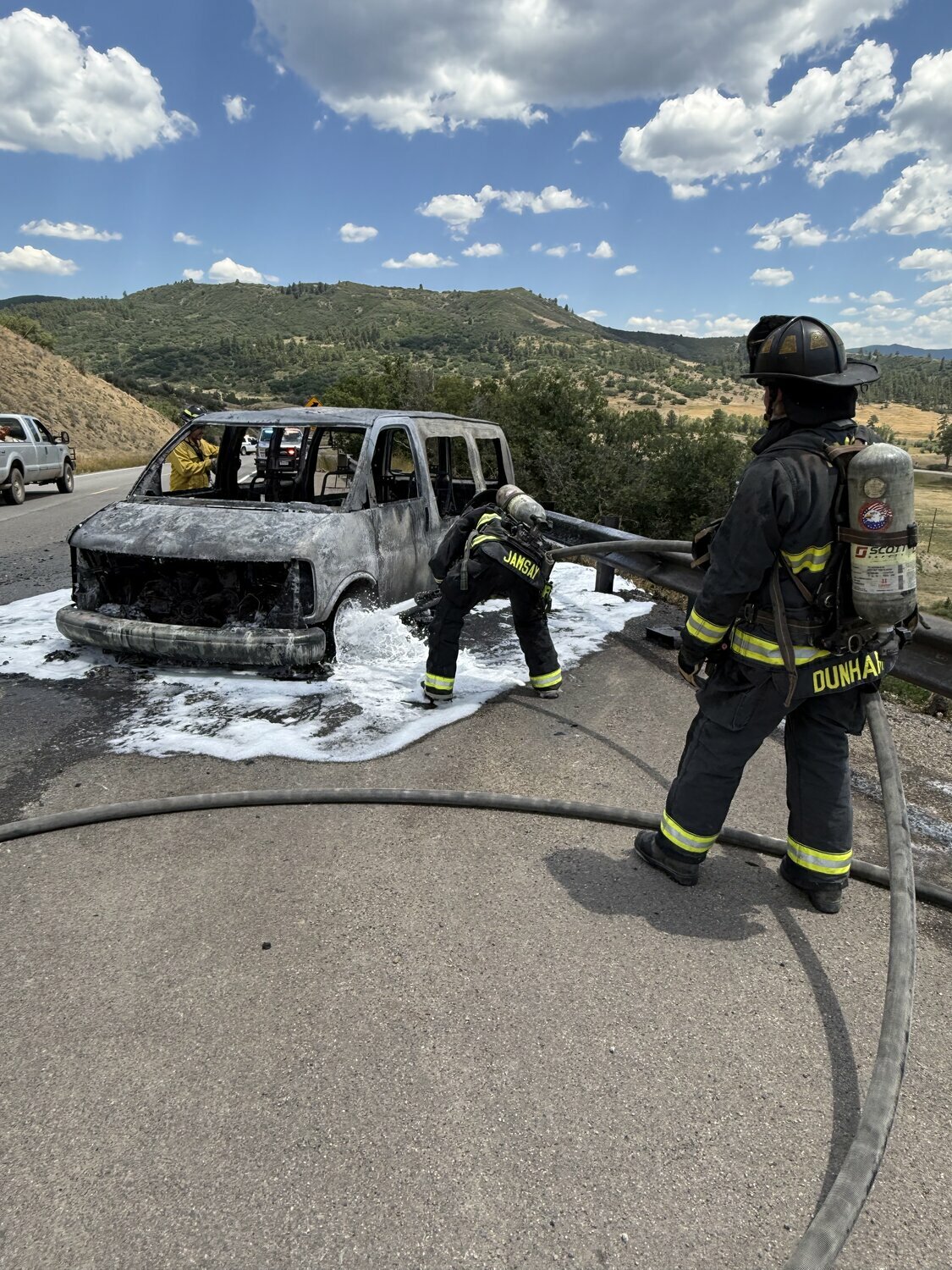Photo courtesy Pagosa Fire Protection District
Pagosa Fire Protection District personnel work to fully extinguish a vehicle fire on U.S. 84 on Monday, July 20. The vehicle started two grass fires before catching fire.