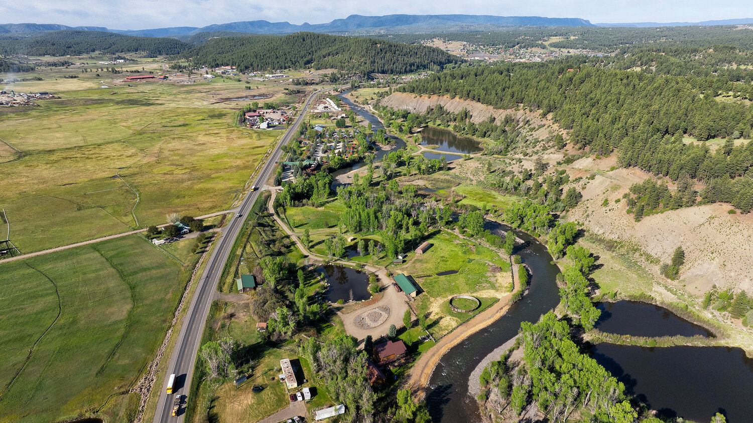 A photo shows the restoration work performed after the October 2025 flooding on the Pagosa Gateway River Project compared to the same stretch during the flooding.