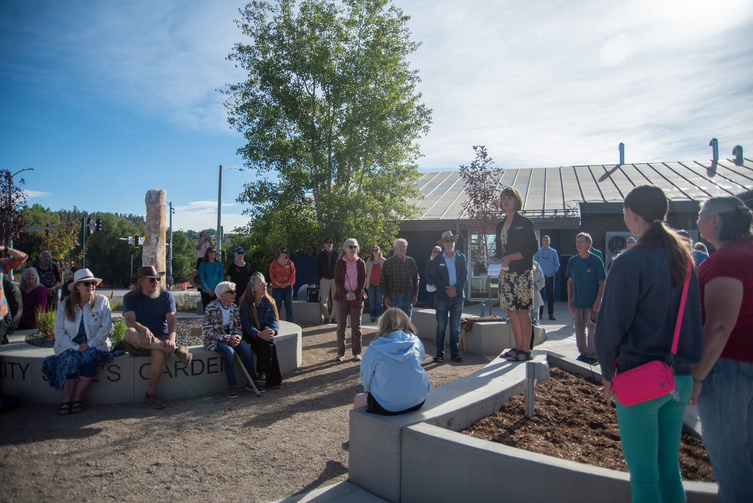 Ruby M. Sisson Memorial Library Director Barbara Brattin addresses the crowd at the Sept. 12 grand opening of the library following a year of construction expanding and renovating the library.