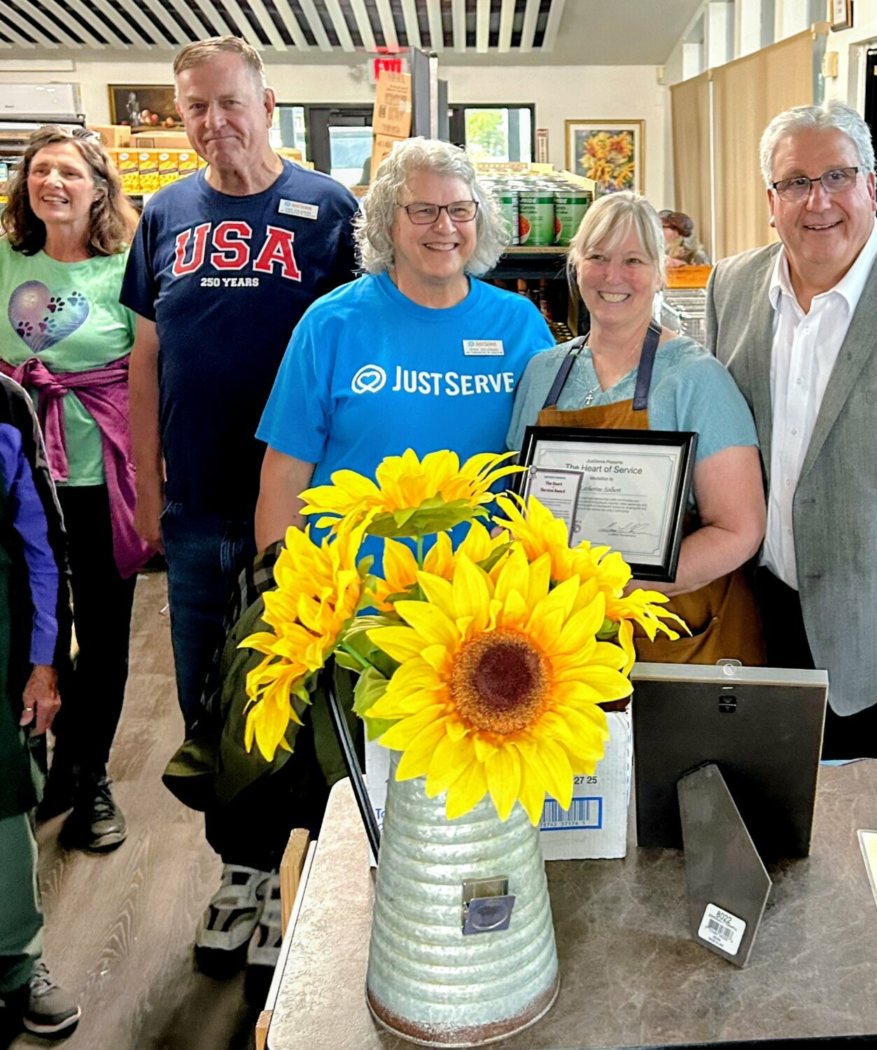 In recognition of her selfless service to the community, Katherine Solbert, executive director of Our Community Eats food pantry, is recognized with the JustServe Hero Award. The award recognizes only one individual/organization each year whose service exemplifies leadership, generosity and commitment to improving the lives of others.