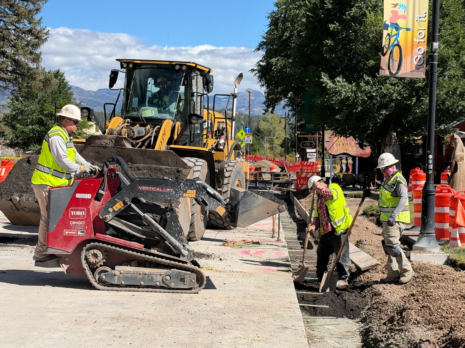 Crews clean up and prepare subgrade for sidewalk, curb and gutter pouring operations after significant rainfall on the 100 block of U.S. 160.