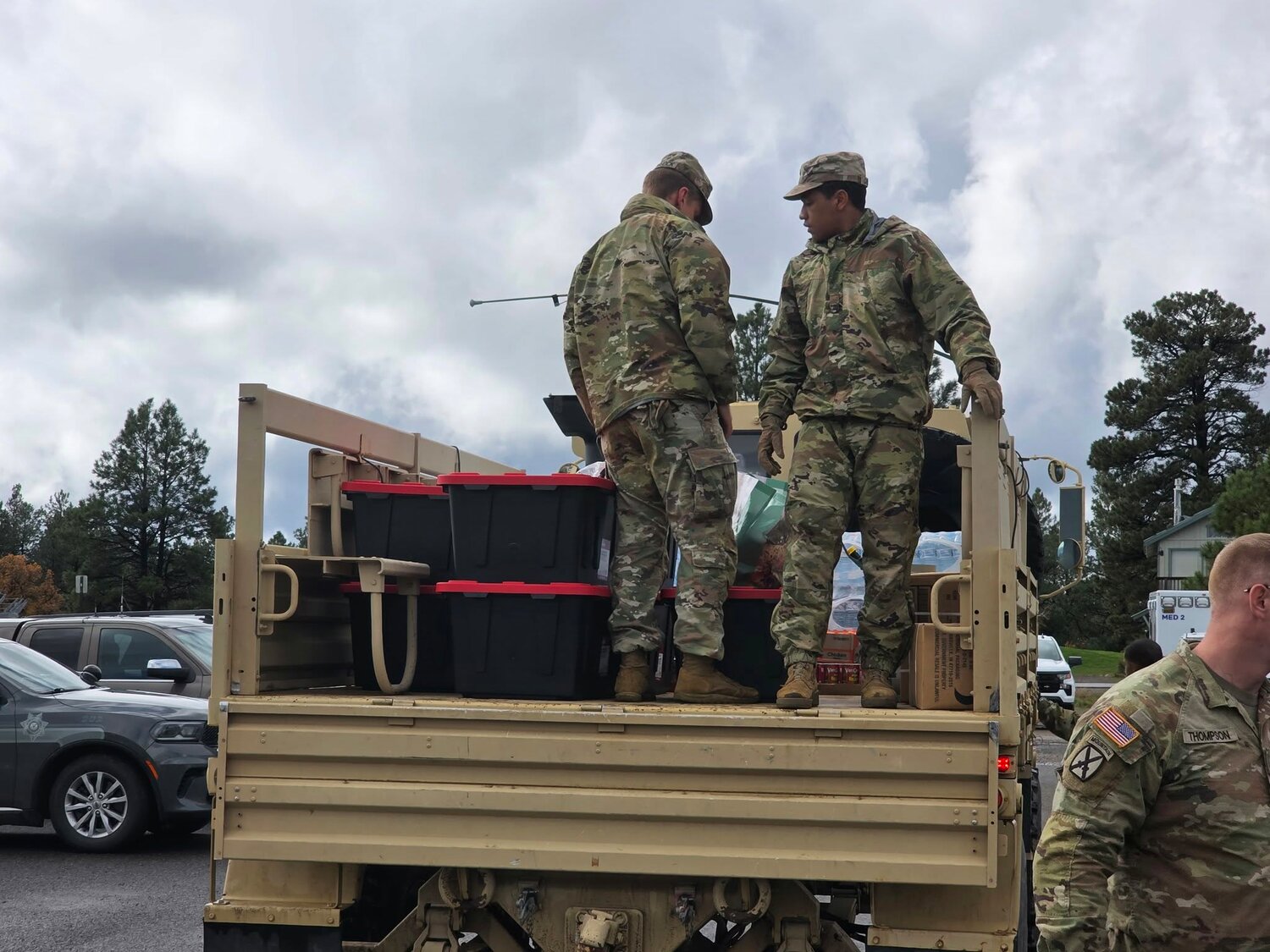 Colorado National Guard personnel load supplies for delivery to the Road 500 area. Morning Operations briefing. Colorado National Guard specialty rescue vehicles.