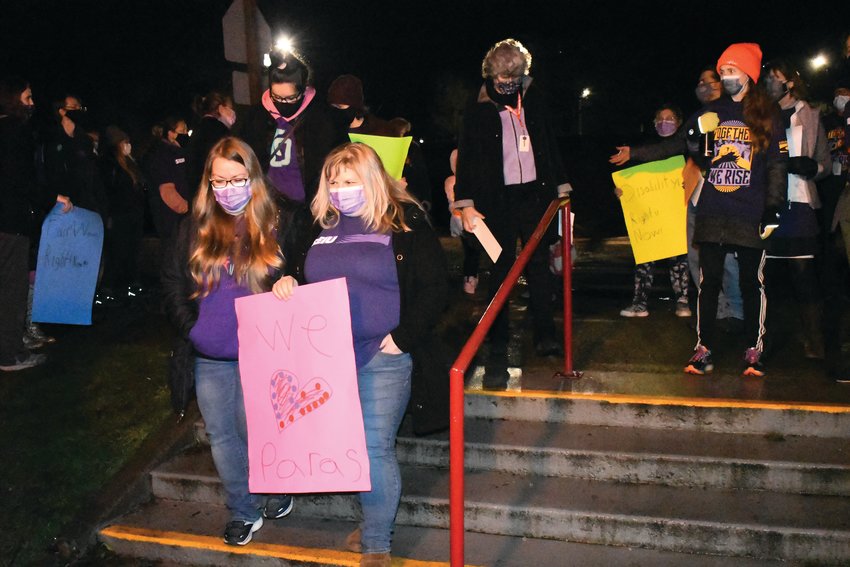 Paraeducators and classified school staff members enter the Port Townsend School district&rsquo;s front office building to attend the board meeting and give public comments advocating for higher wages.