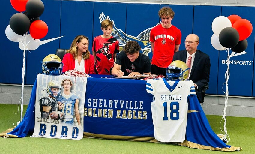 William Bobo (center) officially signs with Austin Peay for football while his younger brother Stephen (top right) looks on. Bobo will play WR for the Governors in the fall.