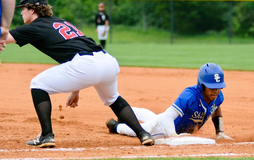 Kyler Trice (blue) slides back safely to first base during his junior season in 2023. 