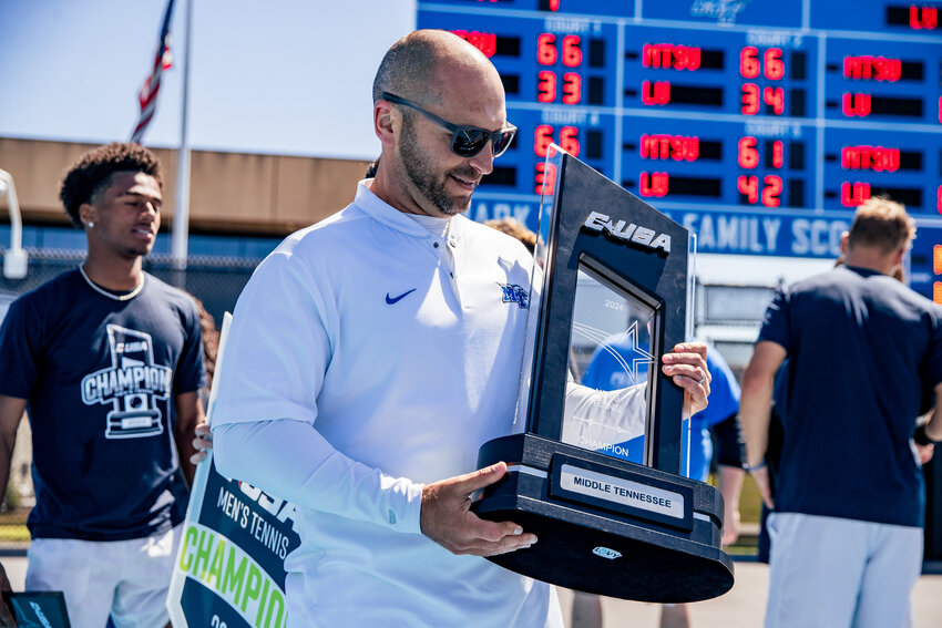 Jimmy Borendame (middle) holds the C-USA Tournament Trophy.