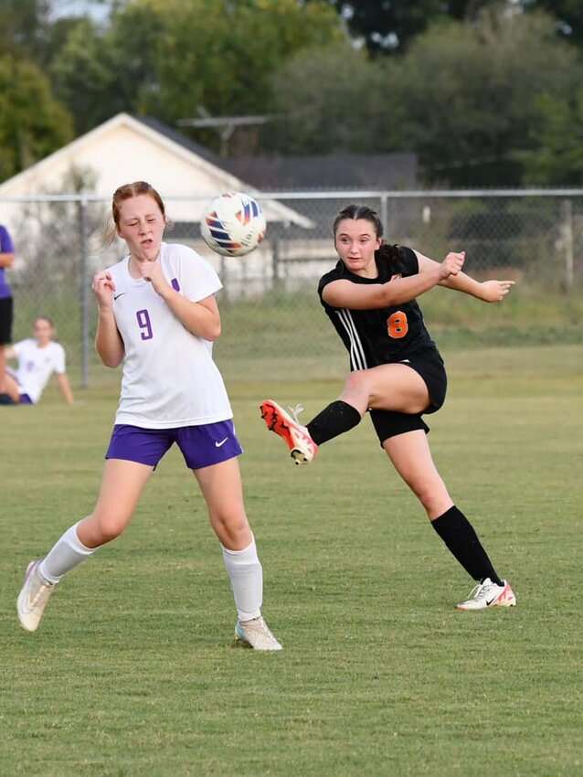 Lexi Comstock (8) beats Abigail Bearden (9) to the ball on Tuesday.