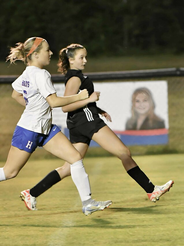 Lexi Comstock (8, black) moments after shooting the District-winning goal.