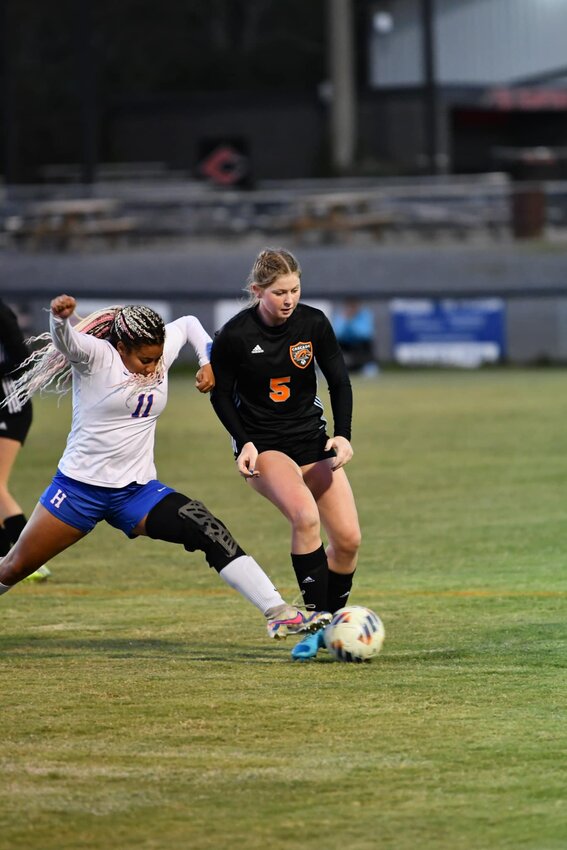 Sophie Ray (5) fends off Hazel Reed (11) in the Region Championship.