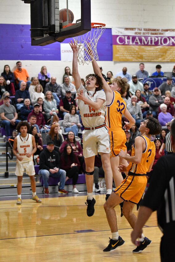 Cooper McElroy (14) lays in two of his 10 second-half points. The freshman made three threes and scored seven points in the fourth quarter to help send the game into OT.