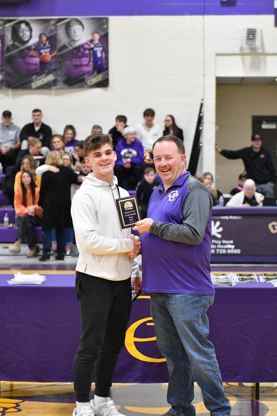 Charlie Haskins (white, 3) was named to the District 9-AA All-Tournament team on Monday night. He also averaged 14.3 PPG for the Vikings over three games.
