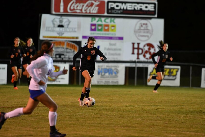 Sophomore Lexi Comstock (8) carries the ball in the Region 5-A Championship game against Huntland last season. Comstock led the team in scoring last year with 11 goals and one assist, and she returns to lead an extremely dangerous attack in Bell Buckle.