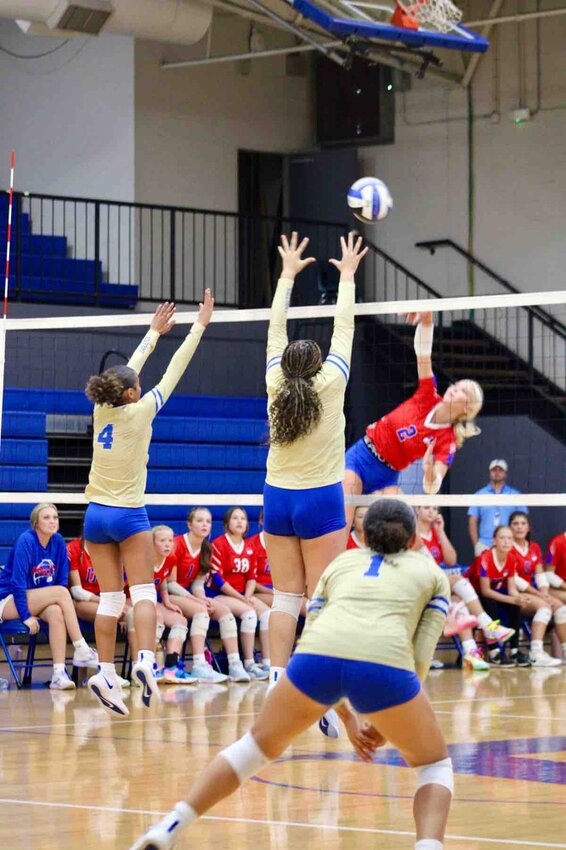 Junior Outside Hitter, Nadiya Locke (4), and sophomore Middle, Jada Berry (25), go up for the block at Chapel Hill.