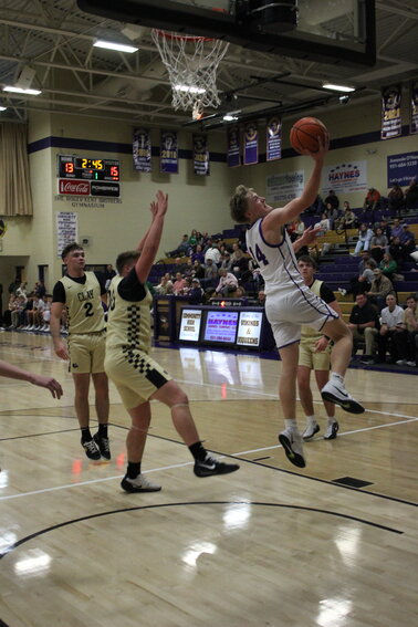 Josh Powers (14) reverses in two of his eight first-quarter points against Clay County. Powers finished with 11 points in Friday's loss.