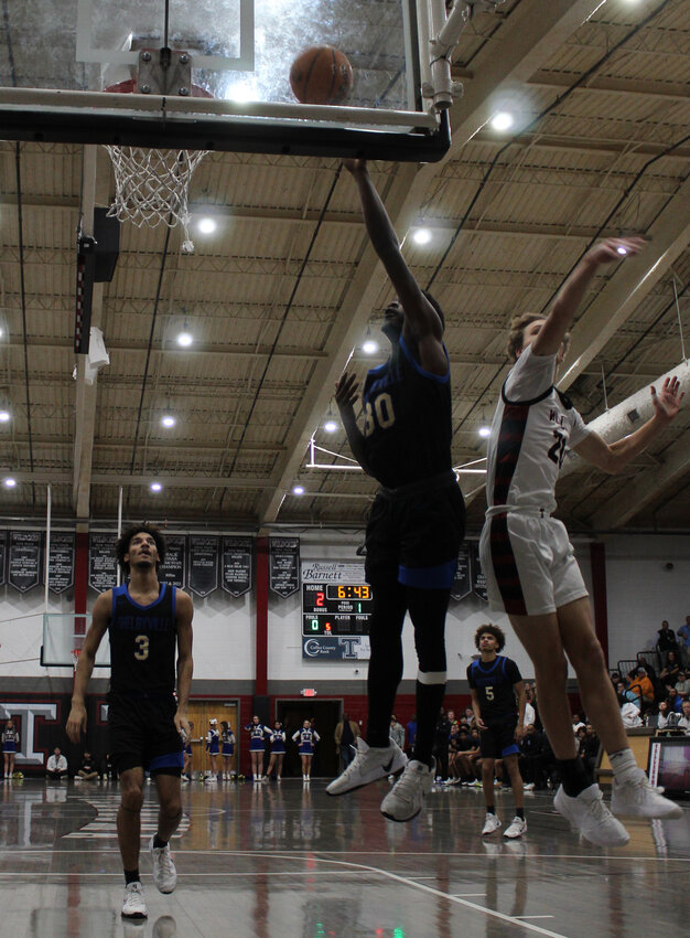 Jevon Lee (30) lays in two of his 12 points in Tuesday's loss at Tullahoma.