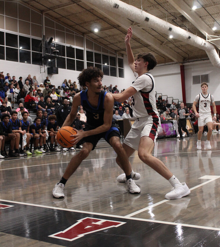Tae'Shawn Shelton (3) looks for a pass against Tullahoma's Jackson Knight (23) scored seven of his 10 points in the second half of Tuesday's loss to the Wildcats.